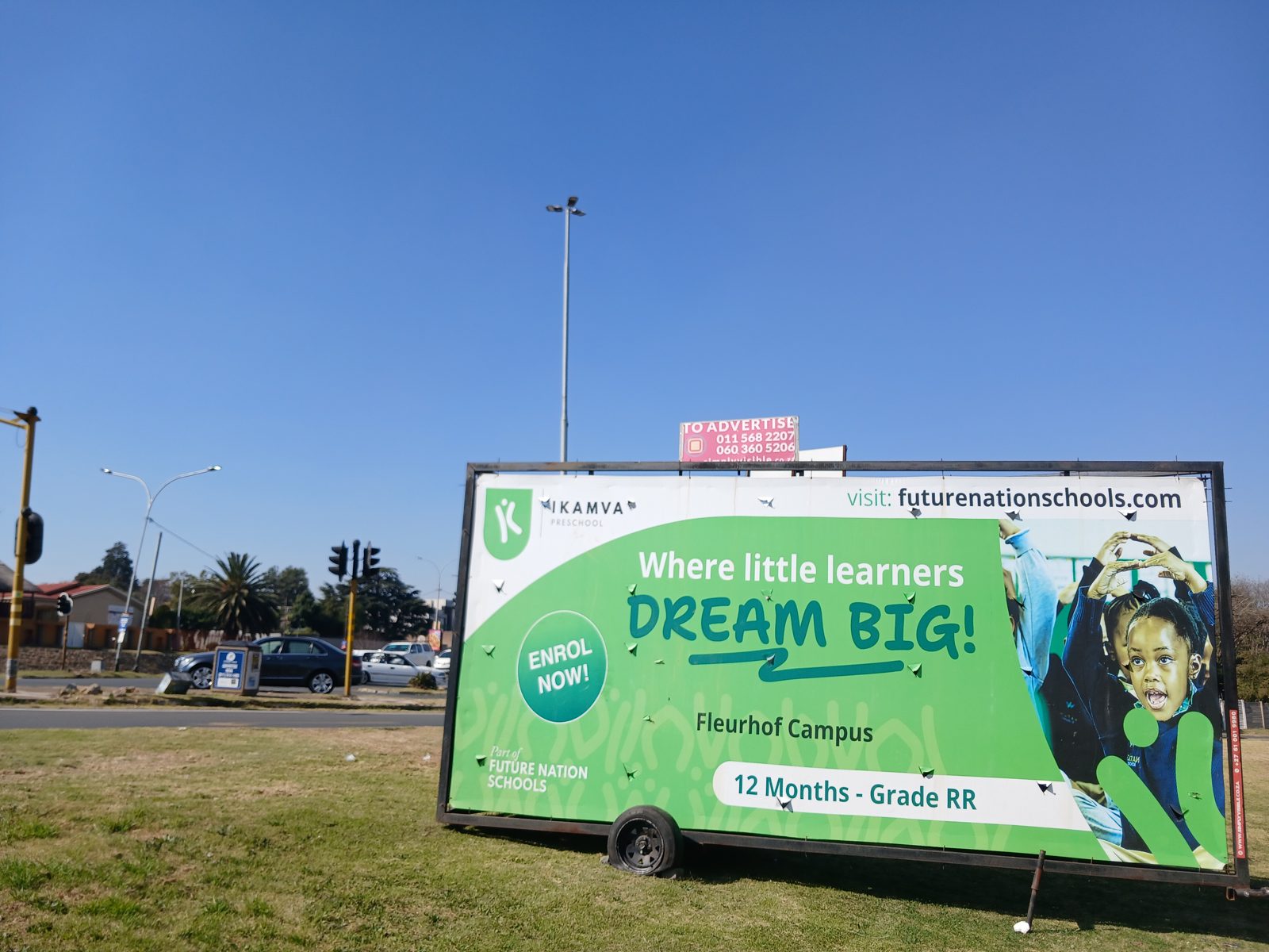 Ikamva Preschool enrolment billboard on a Simply Visible trailer at a busy intersection